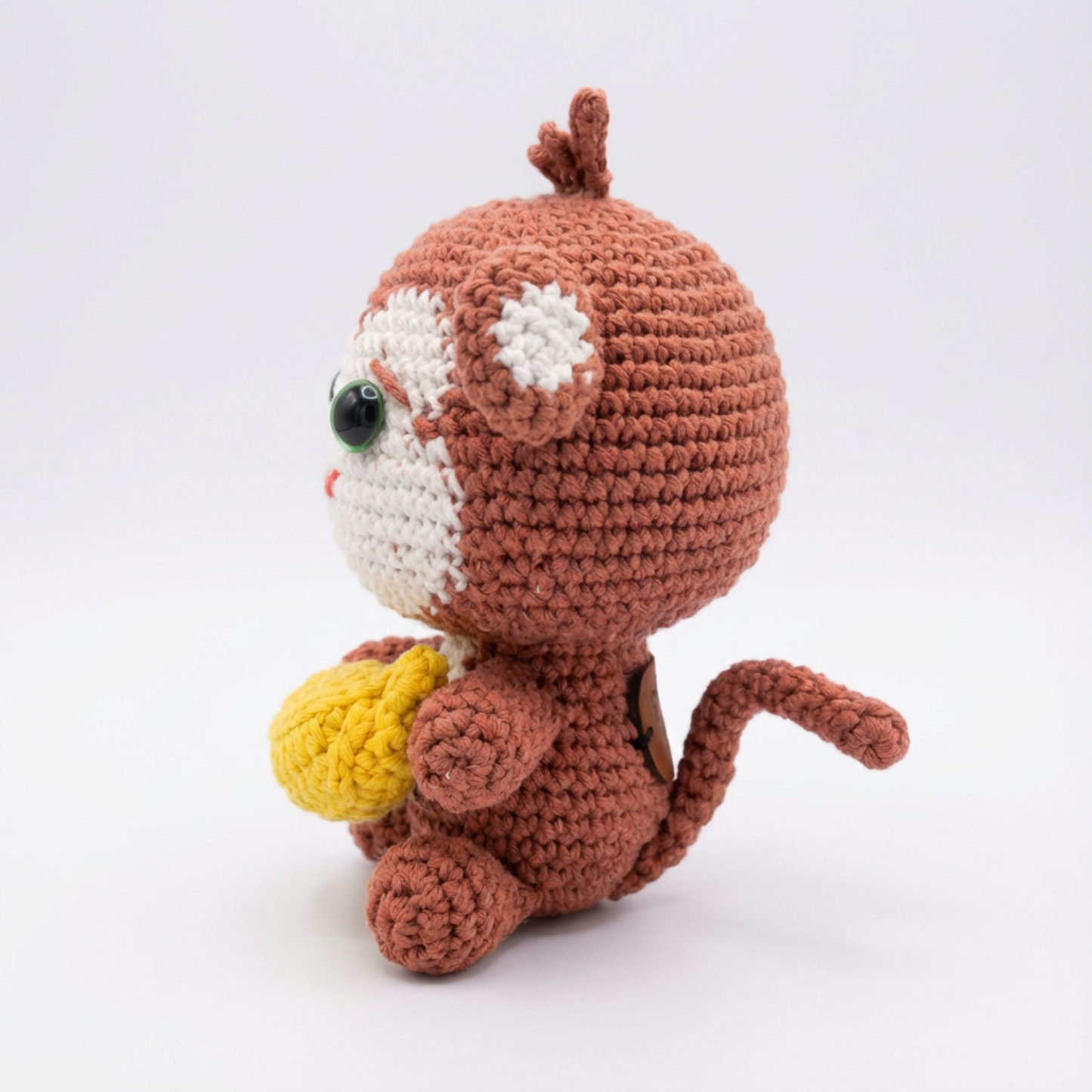 Crocheted monkey toy with a white background